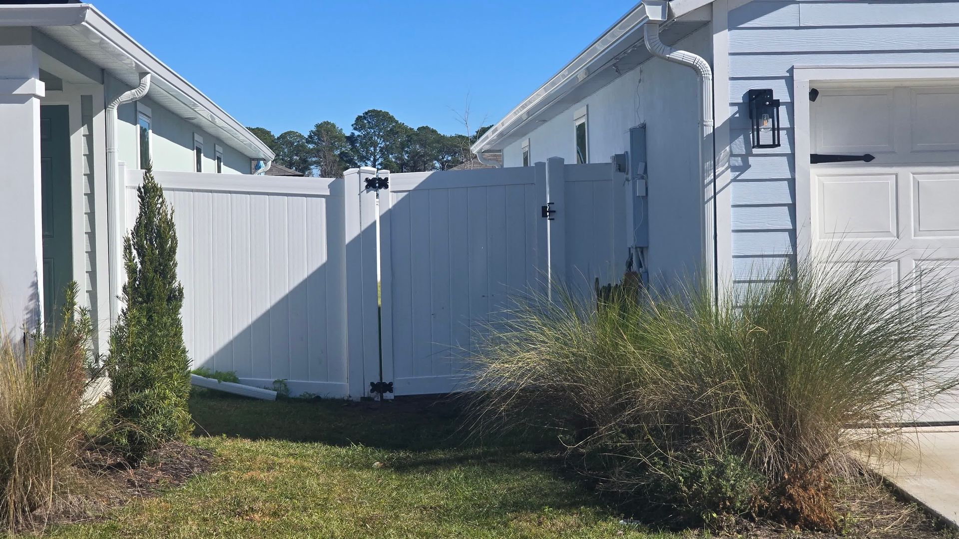 Freshly installed cedar wood fencing running along the yard, providing a natural and appealing boundary.