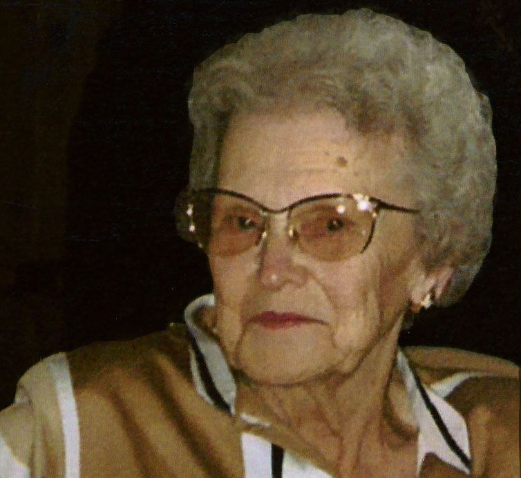 A close up of an elderly woman wearing glasses