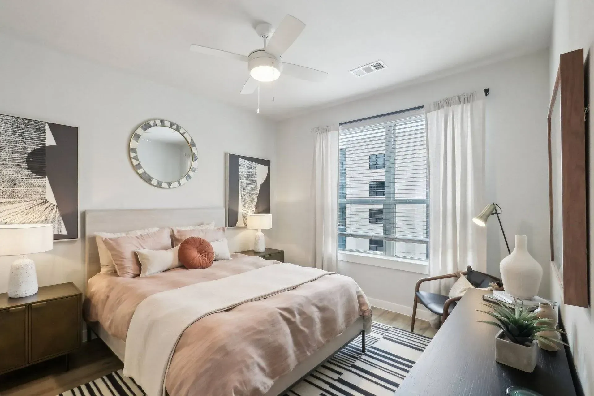 Bedroom with bed, art, a window, and decorative items in a modern style.