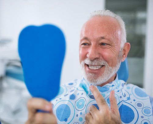 Elderly man at Land O' Lakes dental office smiling