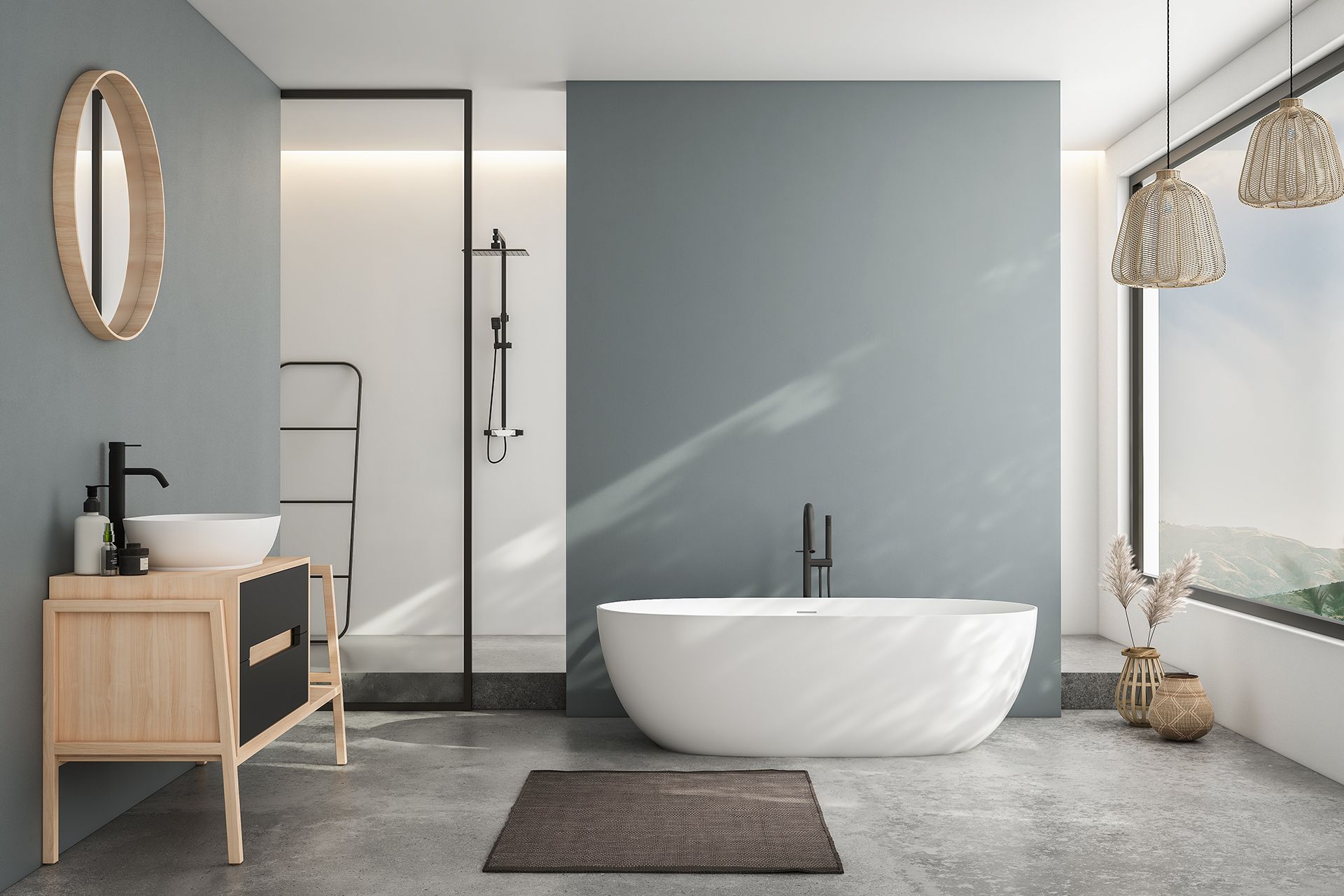 Modern bathroom with a freestanding white bathtub, a blue-grey accent wall, a wooden vanity, and a large window with a mountain view.