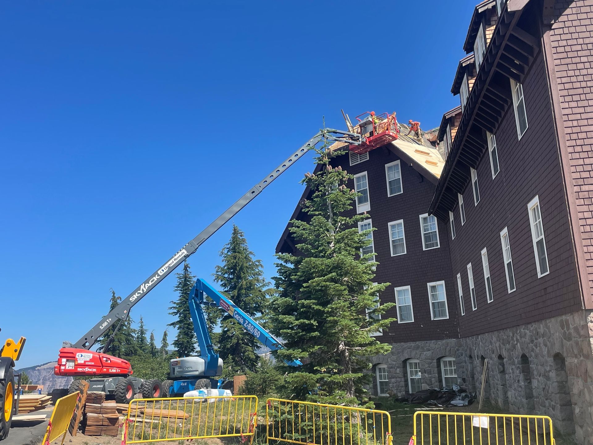 Exterior of a modern building with a glass door, large windows, and a paved walkway. 
