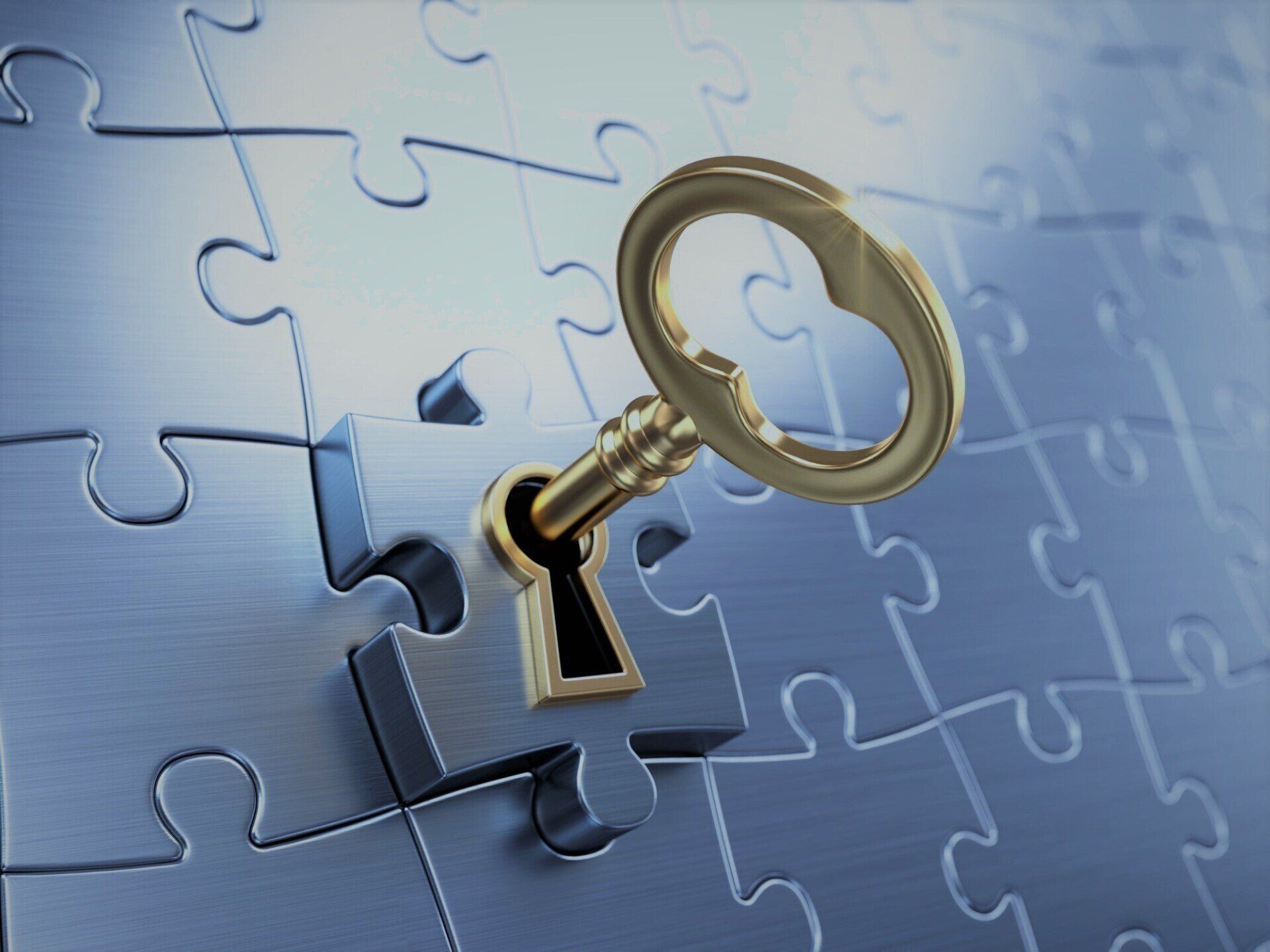 Picture of a brass key insert in a lock on a gray jigsaw puzzle piece