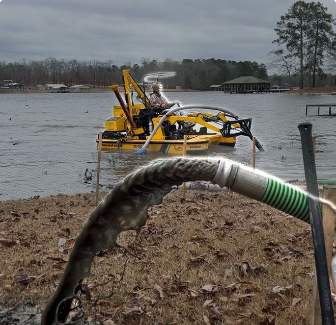 A hose is connected to a yellow boat in the water