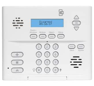 White security system control panel with a display, keypad, and buttons, showing 
