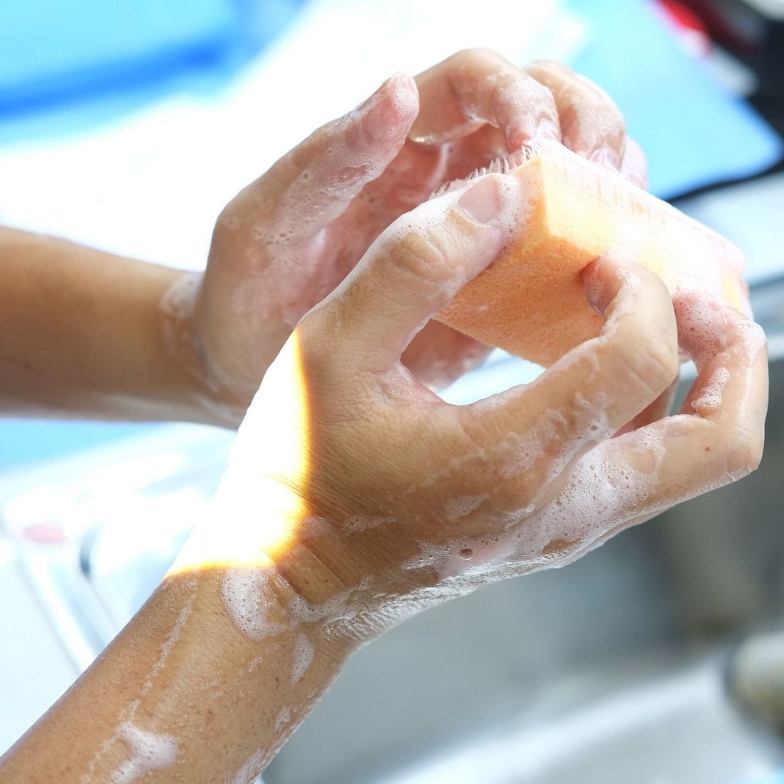 A Person is Washing Their Hands With Soap and Water — New Leaf Dentists in Erina, NSW