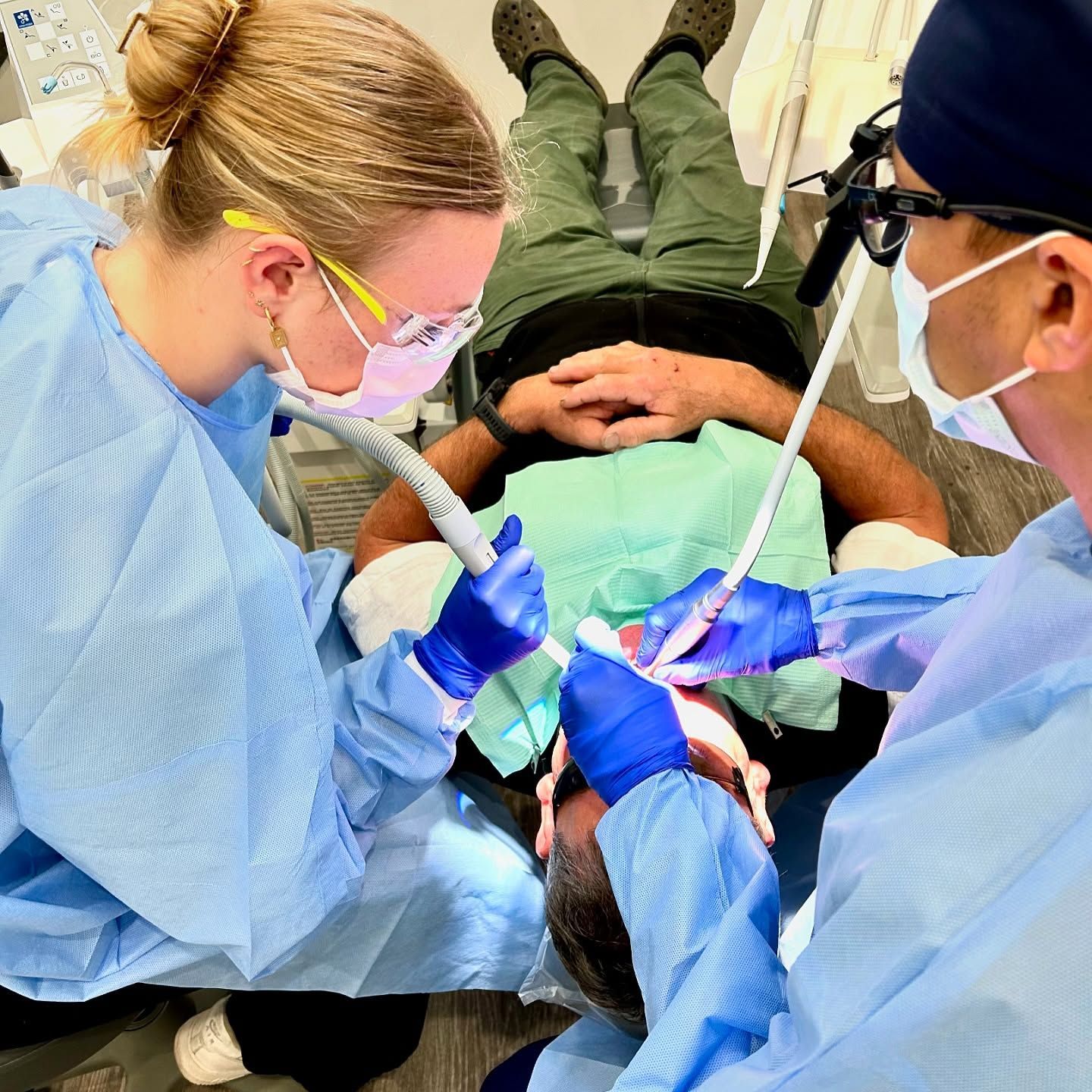 Two Dentists Working on a Patient — New Leaf Dentists In Erina, NSW