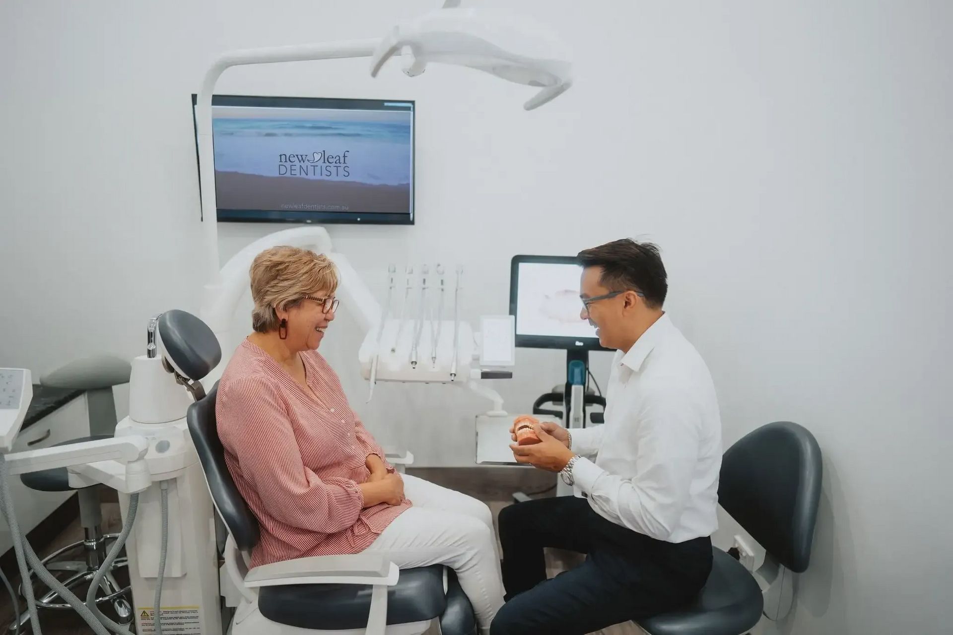 Dentist Consults With a Female Patient — New Leaf Dentists In Erina, NSW