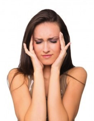 A Woman is Holding Her Head in Pain — New Leaf Dentists in Erina, NSW