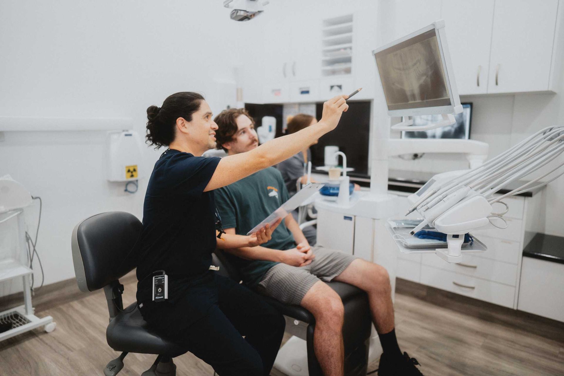 Dentist Pointing at Monitor — New Leaf Dentists In Erina, NSW