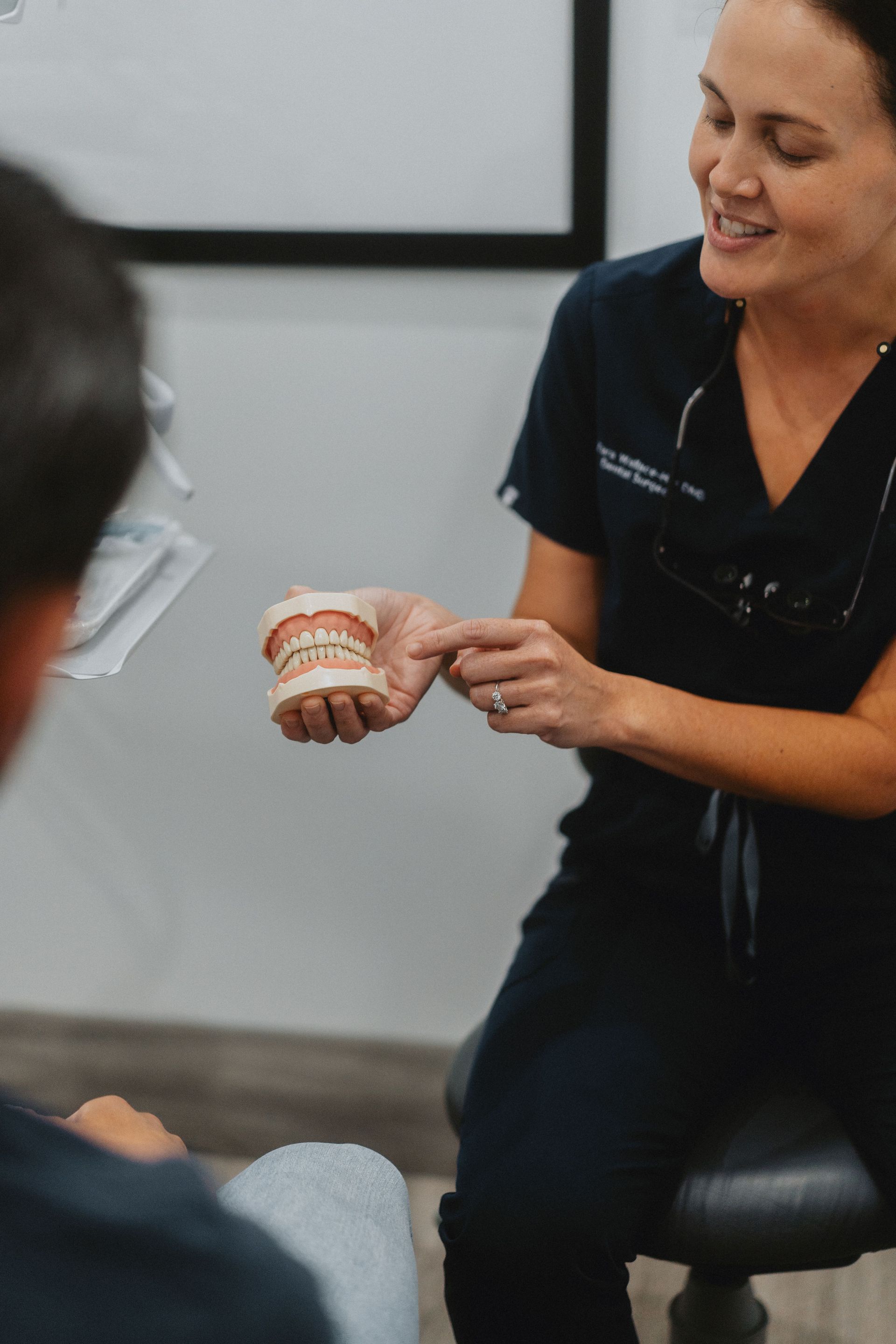 Dentist Showing Teeth Model to Patient — New Leaf Dentists In Erina, NSW