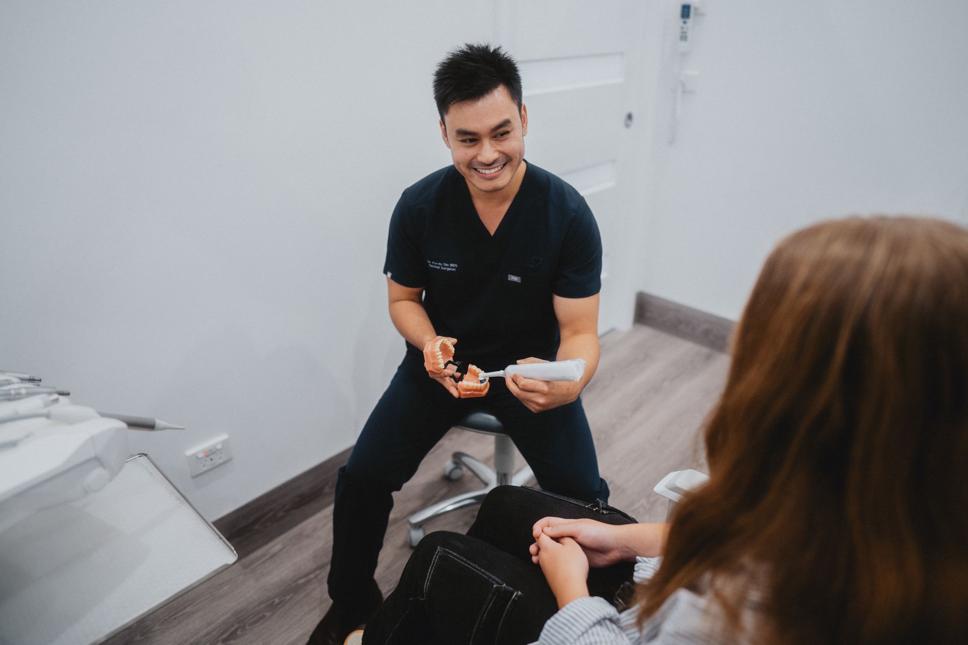 Smiling Doctor Showing a Teeth Mold to a Patient — New Leaf Dentists In Erina, NSW