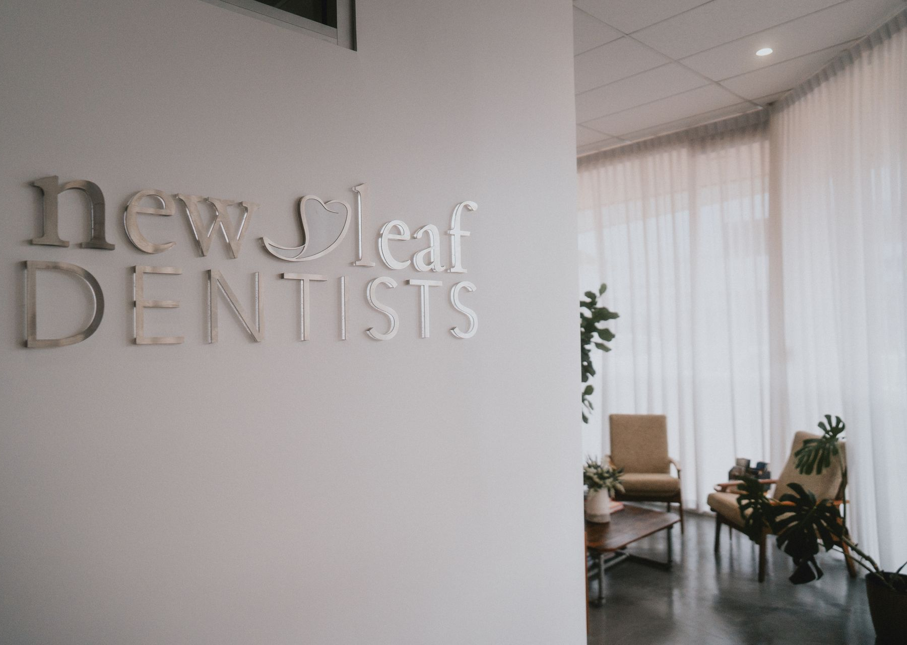 Silver Lettering on a White Wall — New Leaf Dentists In Erina, NSW