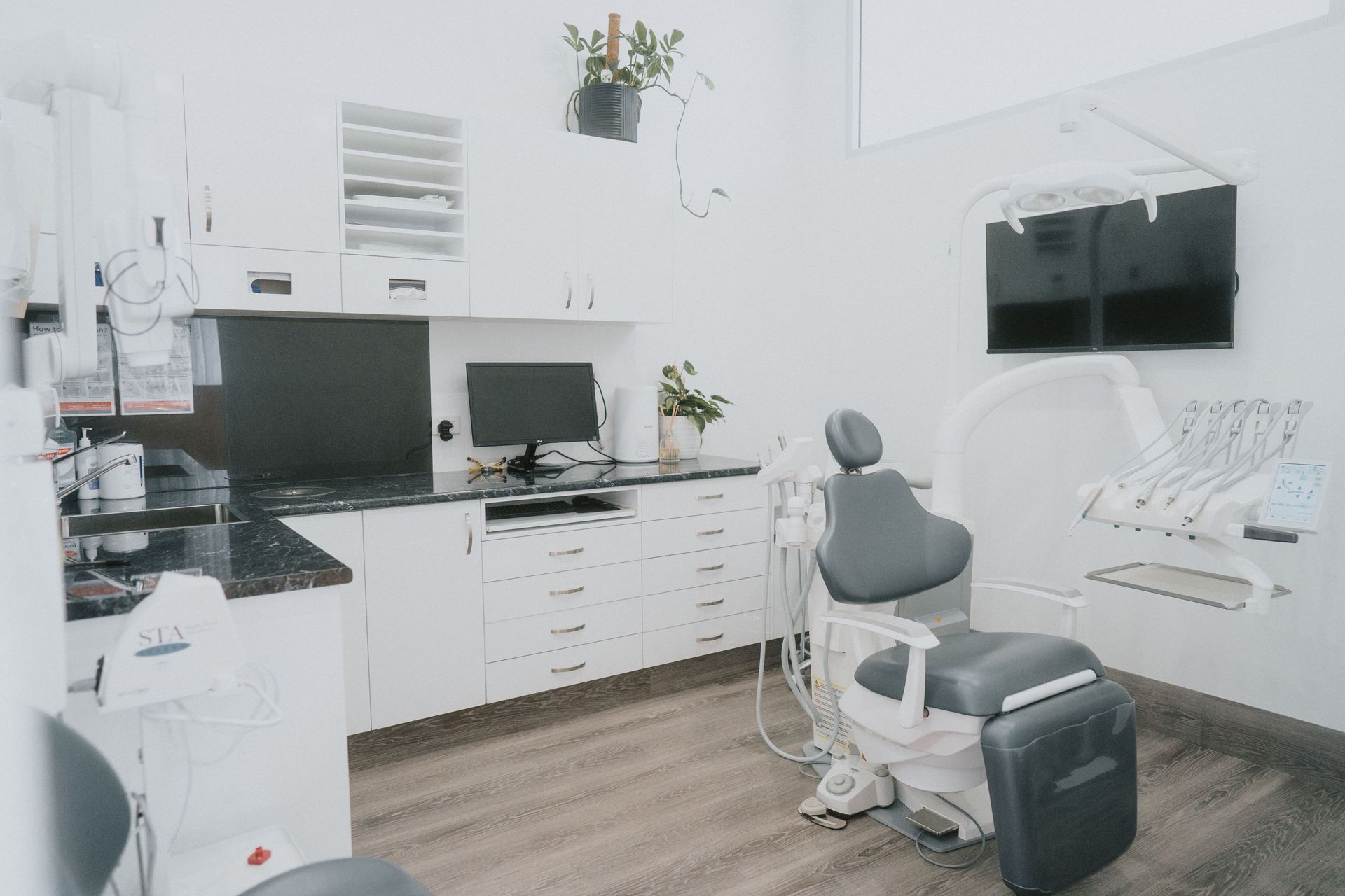 A Dental Professional Points to a Digital X-ray Screen — New Leaf Dentists In Erina, NSW