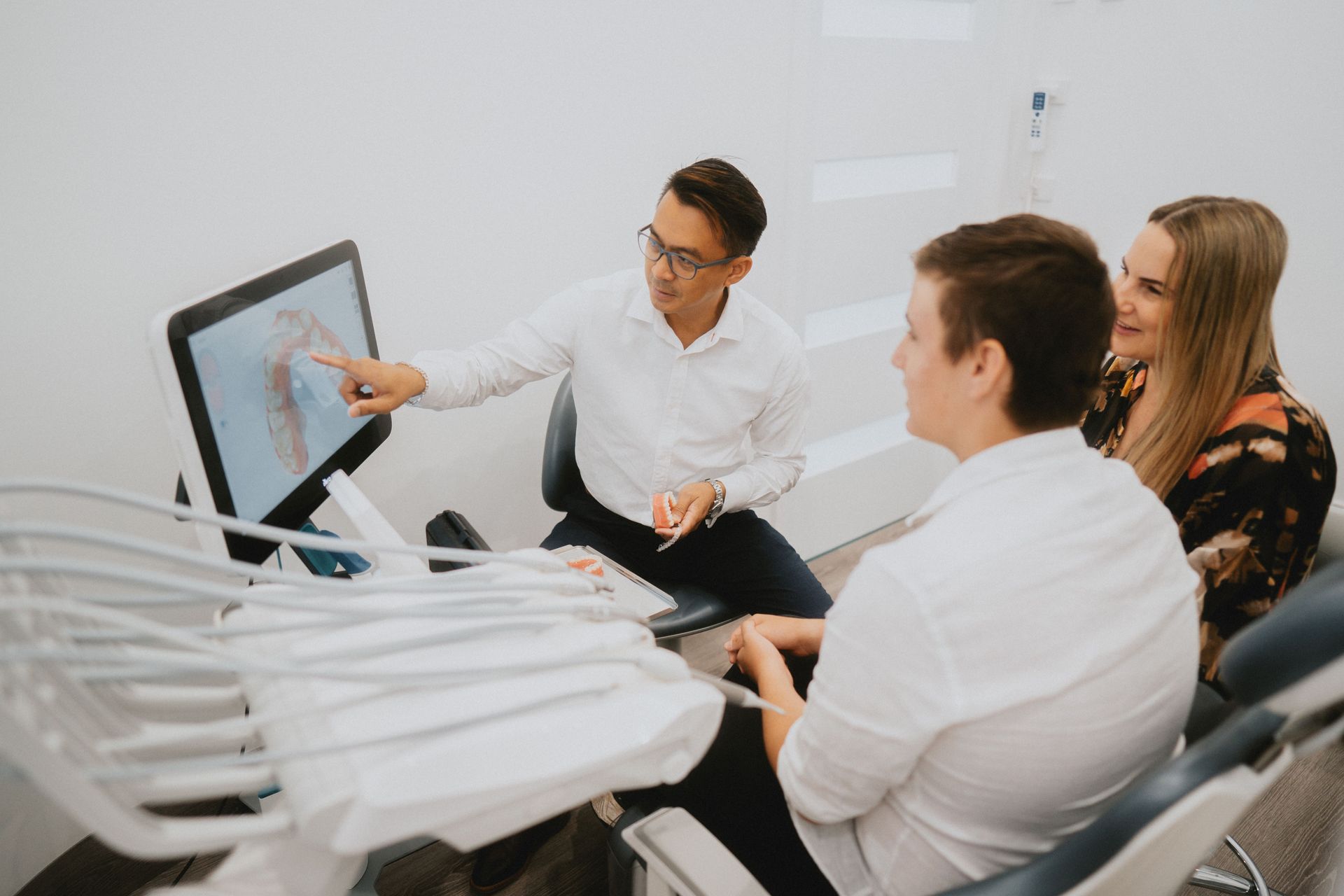Dentist Pointing at a Digital X-Ray on a Screen — New Leaf Dentists In Erina, NSW