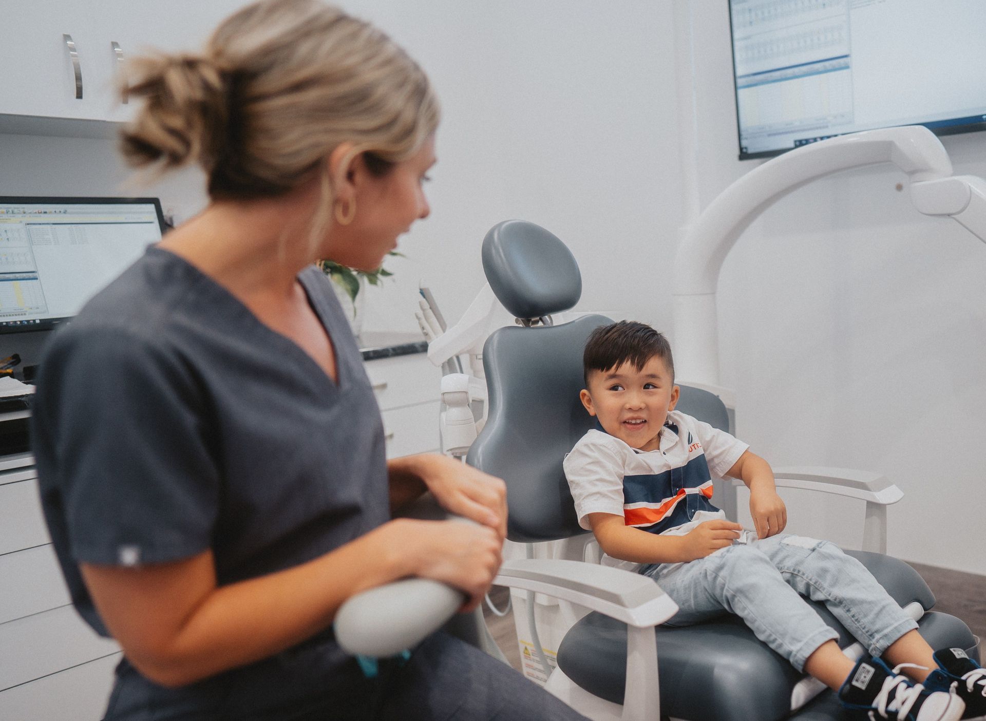 A Healthcare Professional in Gray Scrubs Talks — New Leaf Dentists In Erina, NSW