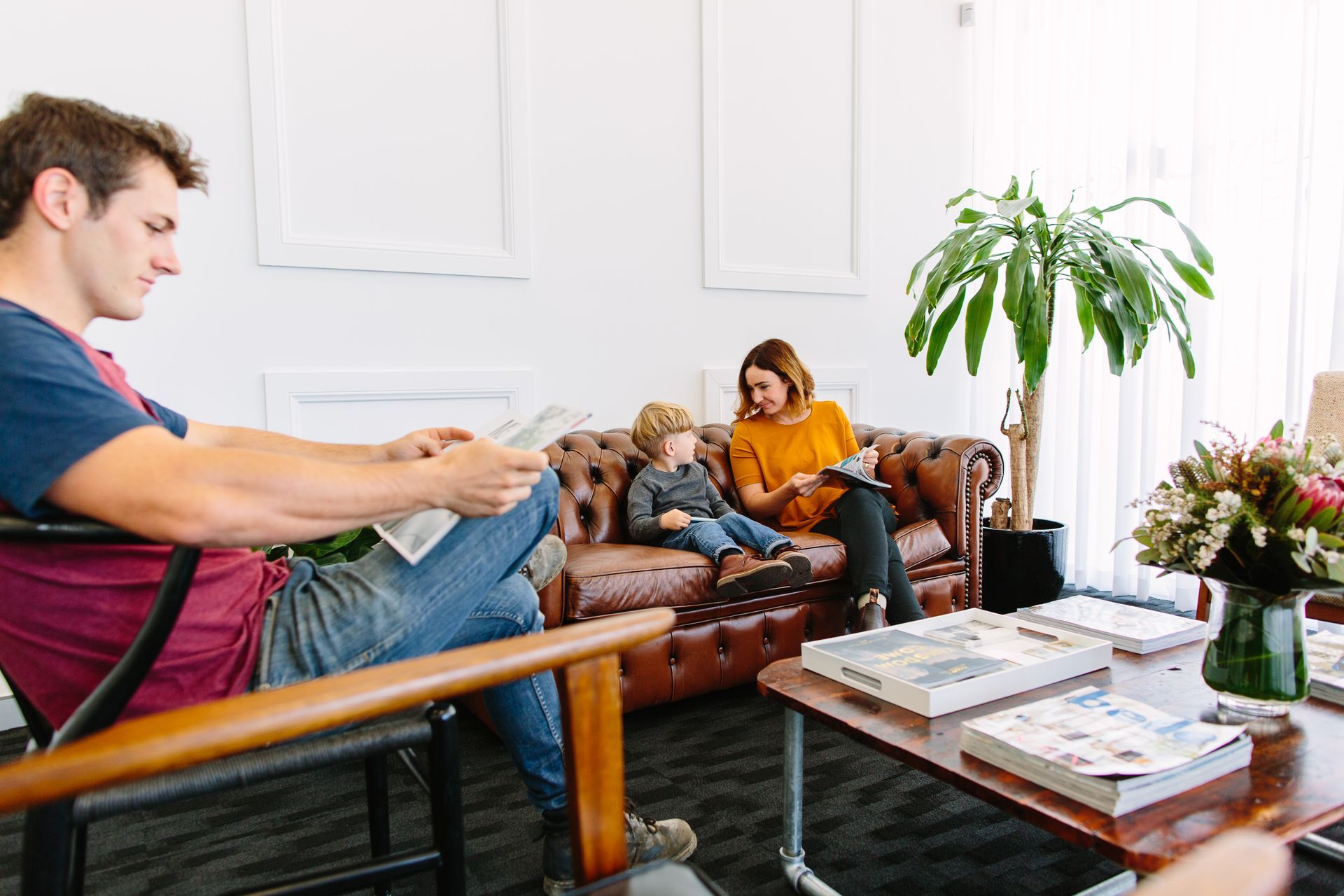 Man Reading in Chair — New Leaf Dentists In Erina, NSW