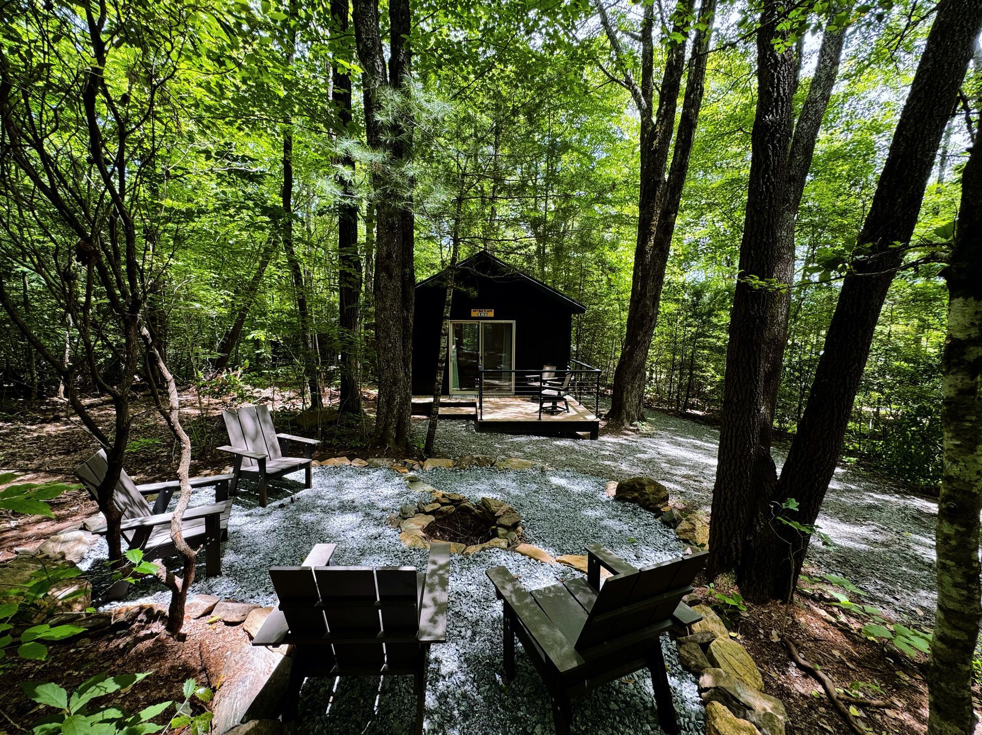 A bedroom with a king size bed , two nightstands , and two windows.