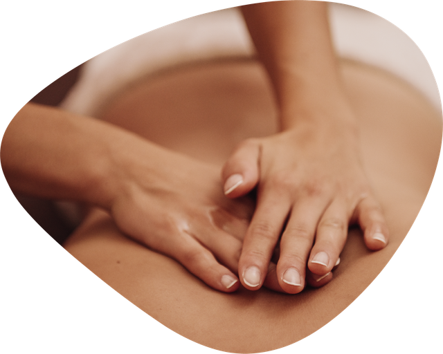 A person is getting a massage with their hands on their back.