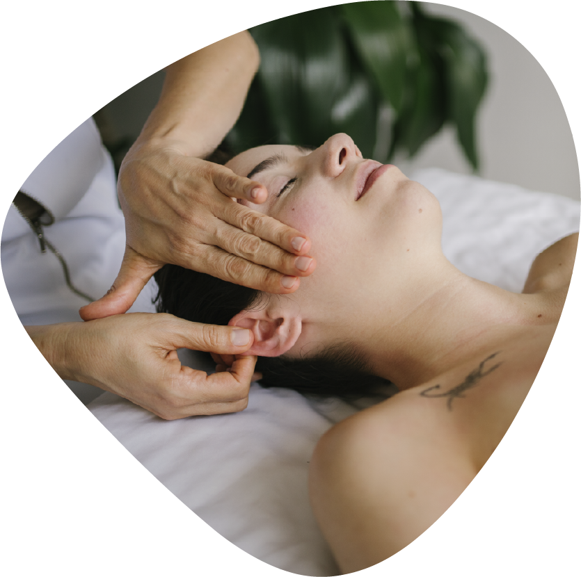 A person is getting a massage with their hands on their back.