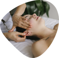 A woman is getting a massage on her neck.