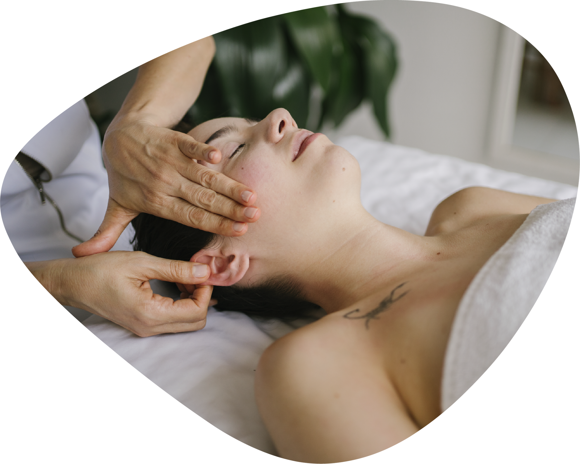 A woman is getting a head massage from a person.