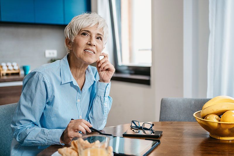 A woman who understands why seniors are falling more often and how to help, links arms with her moth