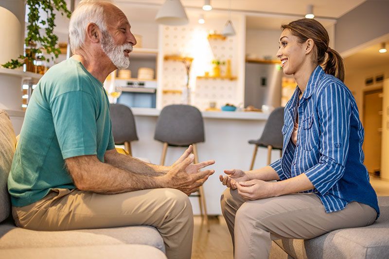 A man is working to improve Parkinson’s speech challenges as he talks with his caregiver.