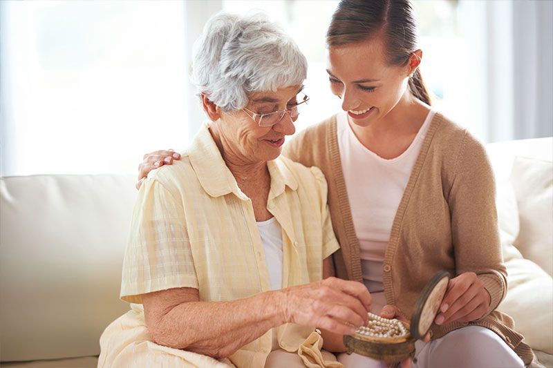 caregiver redirects an older woman who had been engaging in unsafe behaviors in dementia by showing 