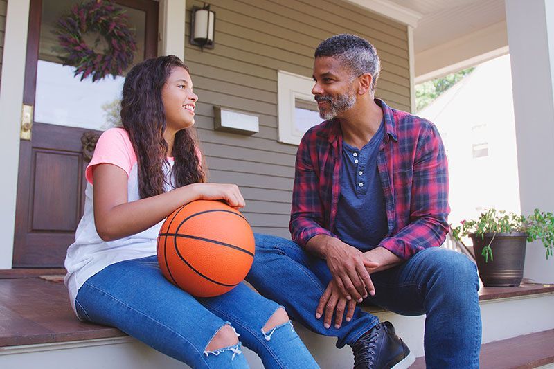 A man who knows how to best answer kids’ questions about dementia talks with his daughter on the fro