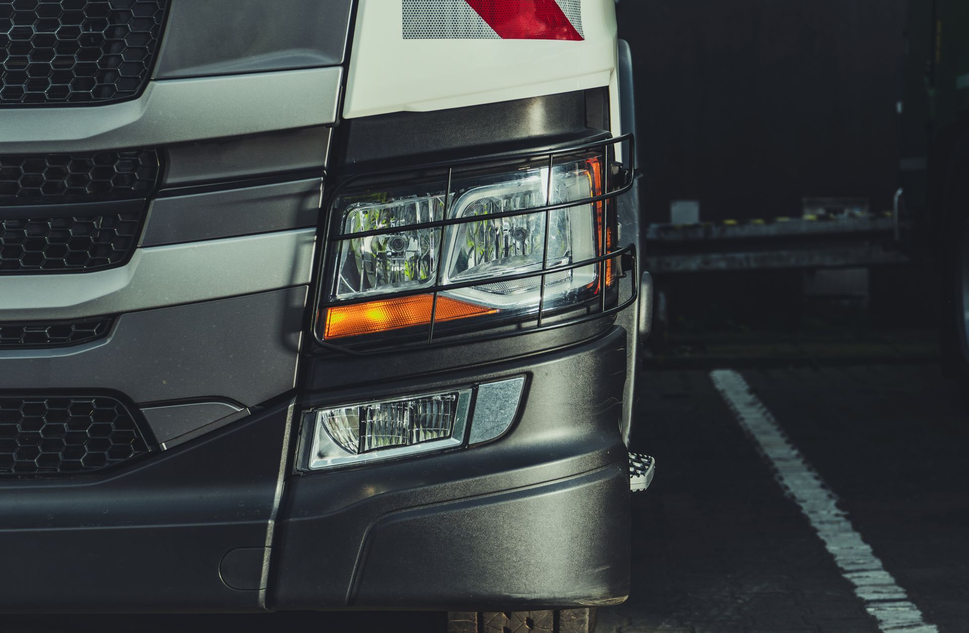 Close-up of a truck front, showcasing truck parts and accessories, focusing on headlight assembly.