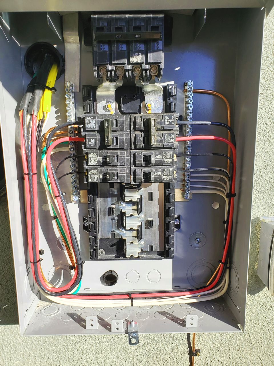 Electrical breaker panel with numerous circuits and wires.