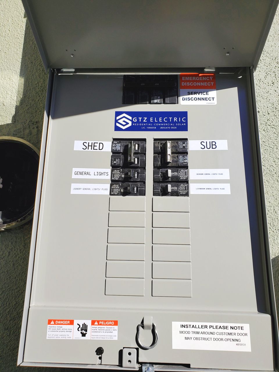 Electrical sub panel with circuit breakers, labeled 