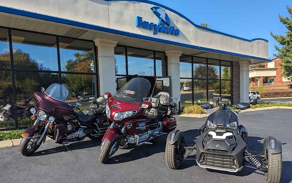 Touring motorcycles and a 3-wheel Can-Am trike in front of our Cleveland, TN showroom