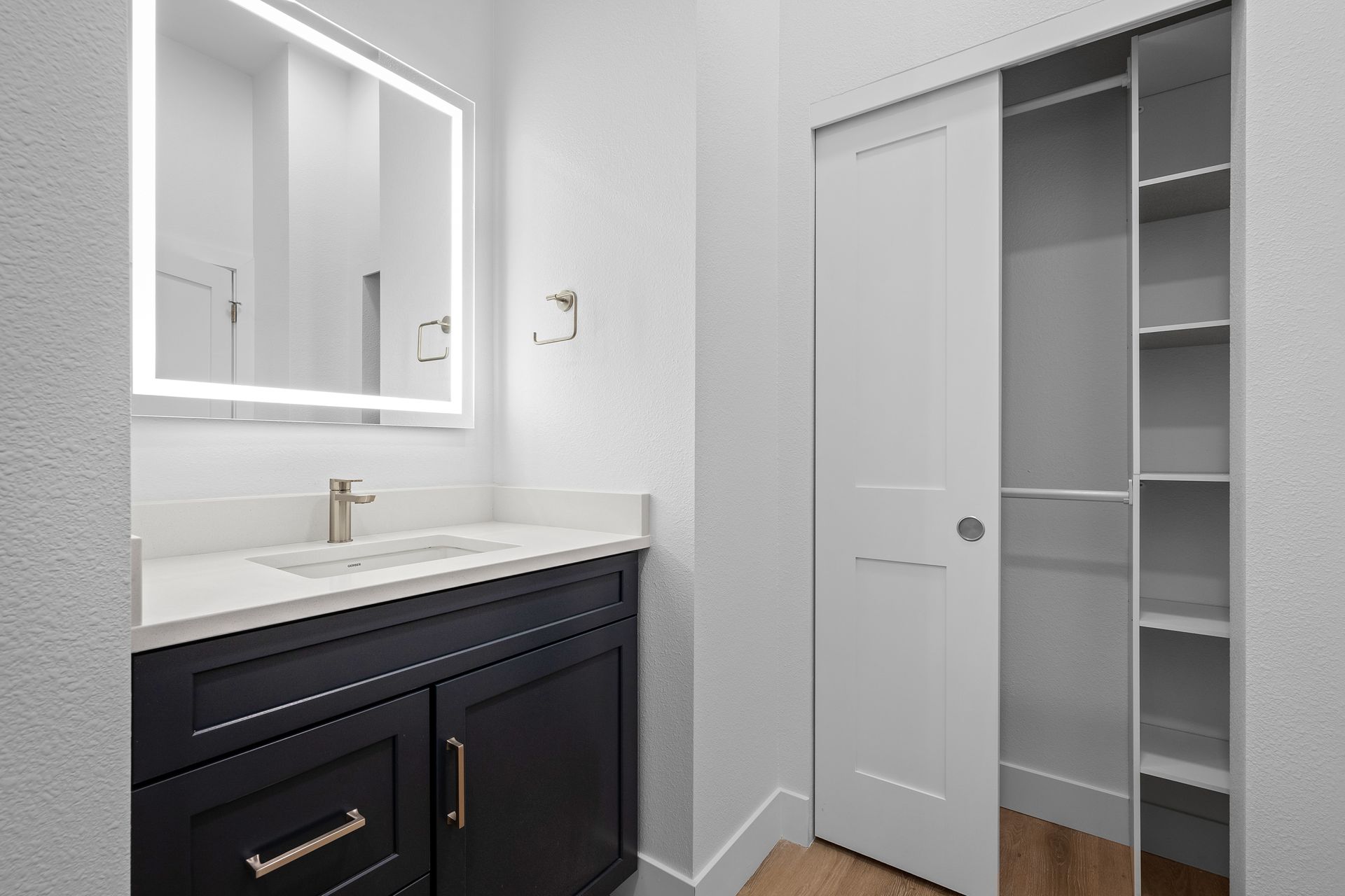 photo showing bathroom with vanity mirror and attention to detail in design, closet included