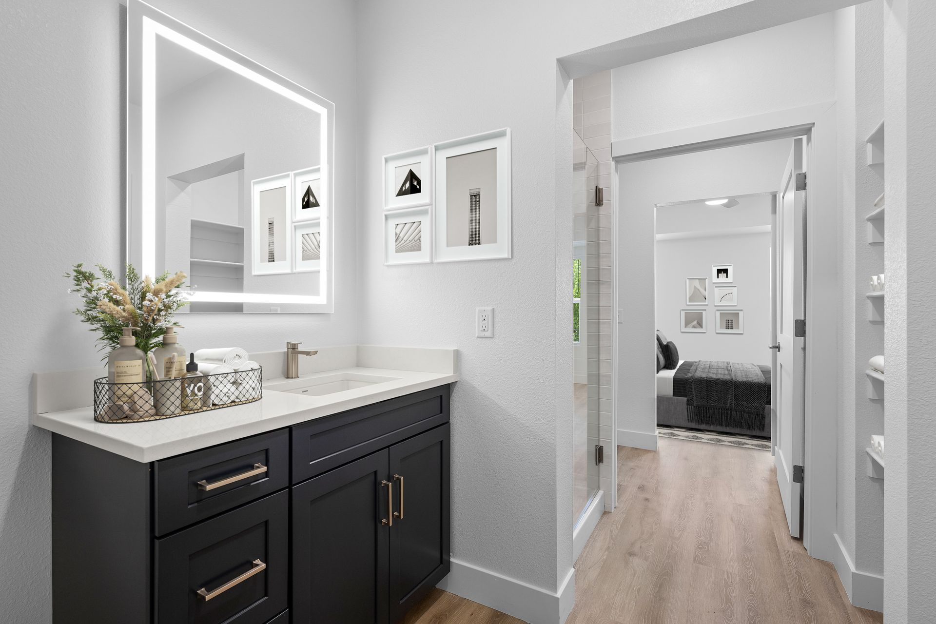 photo showing bathroom counter with a bedroom in the background