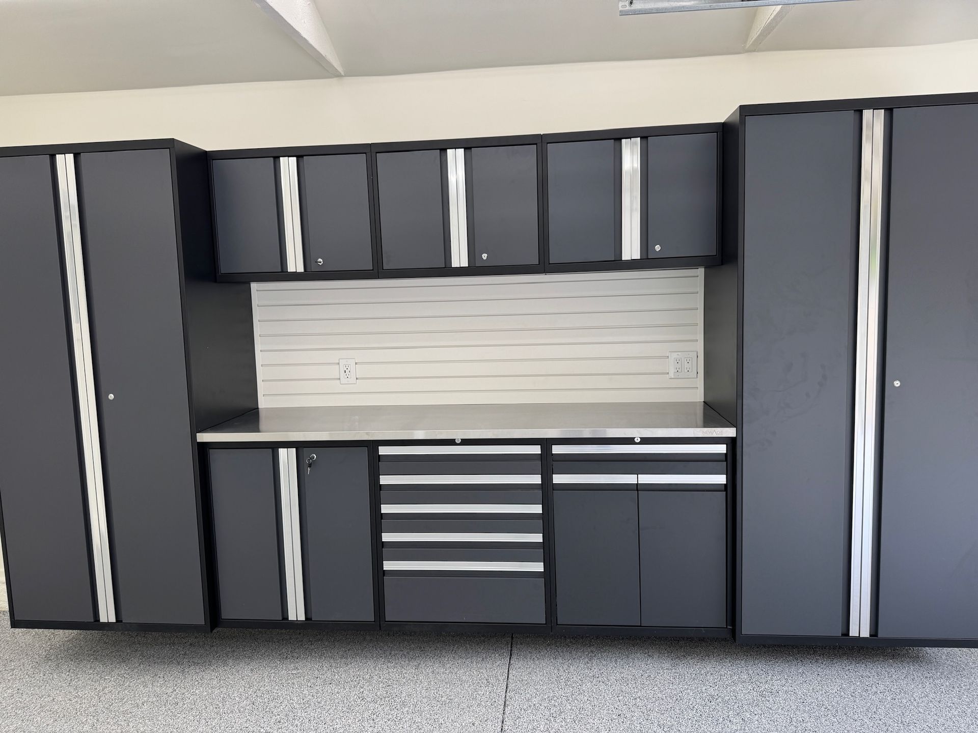 A man wearing a hard hat and goggles is standing in a room.