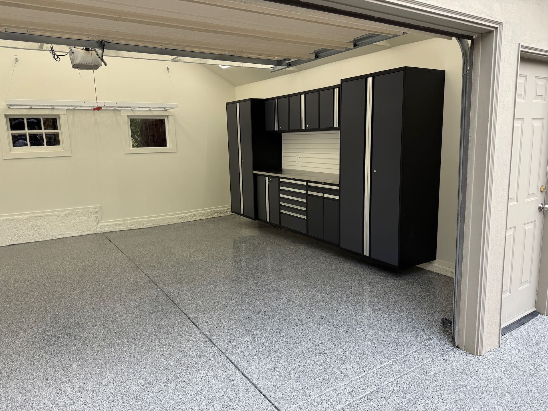 A yellow excavator is sitting on top of a pile of gravel.