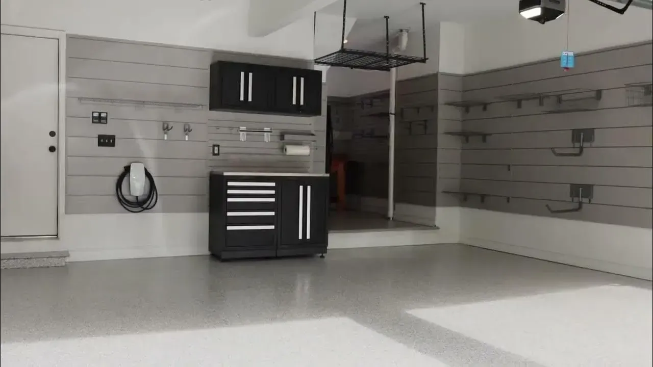 A yellow excavator is sitting on top of a pile of gravel.