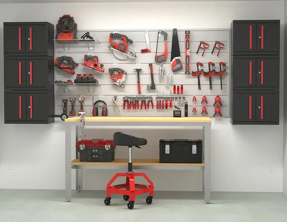 A well-organized garage workshop with tools, work bench, cabinets, and a rolling stool.