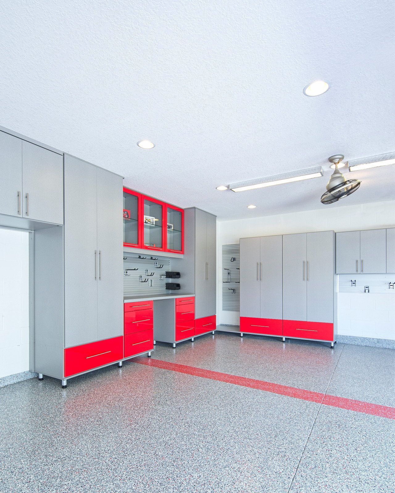A man wearing a hard hat and goggles is standing in a room.