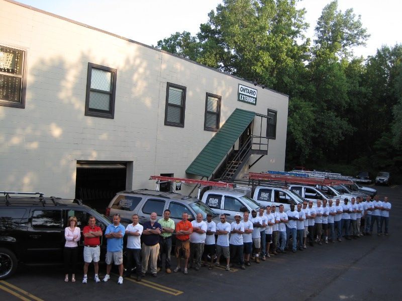 White building with green roof and white gutters against a clear blue sky. White building with green roof and white gutters against a clear blue sky.