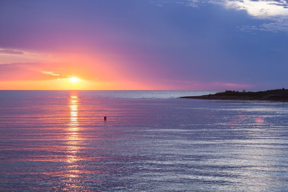 A Sunset Over The Ocean With A Buoy In The Water — Troy Cummings Locksmith In Weipa, QLD