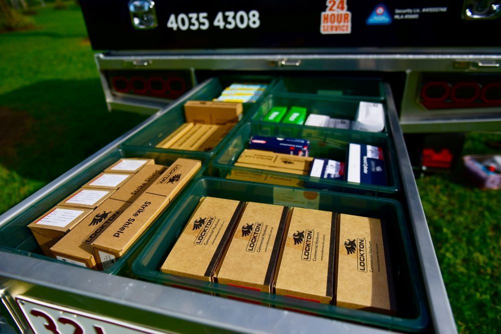 A Bunch Of Boxes Are Sitting In A Drawer On The Back Of A Truck — Troy Cummings Locksmith In Auruken, QLD