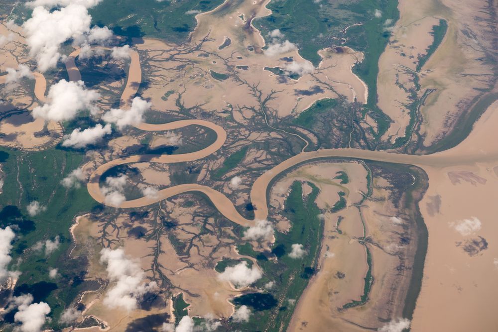 An Aerial View Of A River Surrounded By Trees And Clouds — Troy Cummings Locksmith In Normanton, QLD