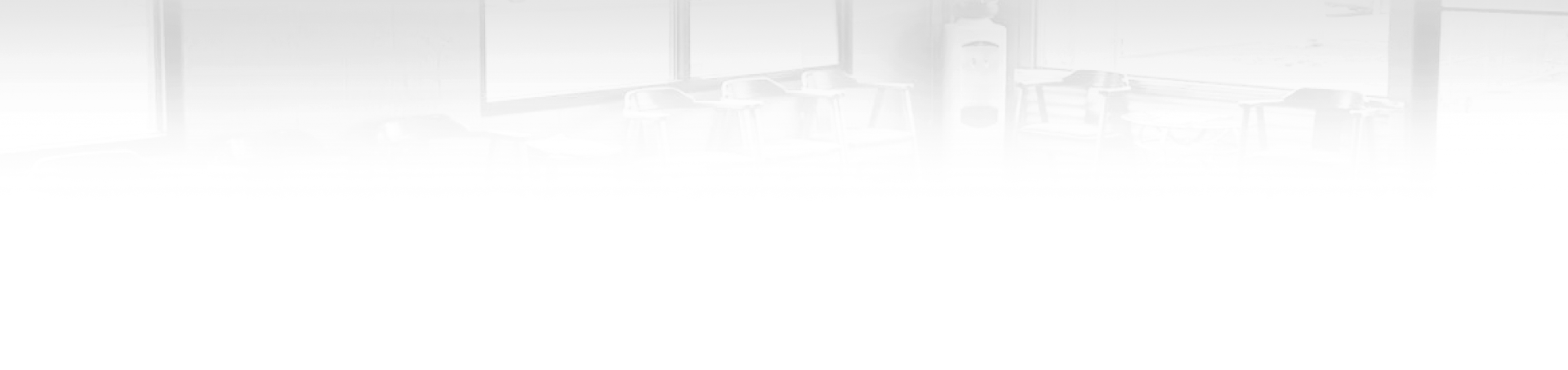 Abstract grayscale cityscape, buildings fading into the background.