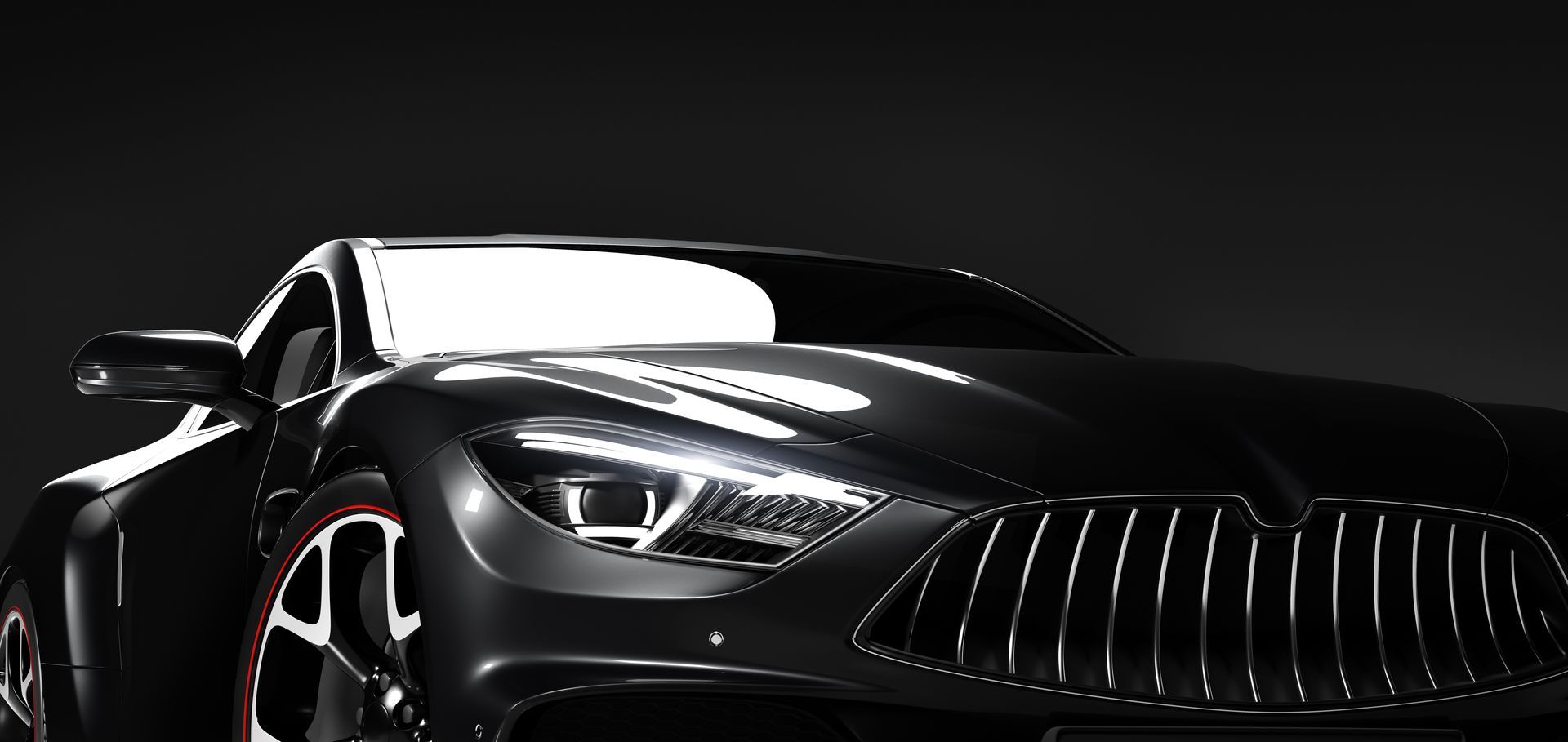 Sleek black car with bright headlights on a dark background.
