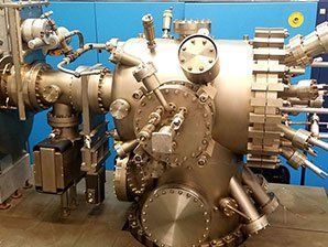 A large metal machine is sitting on a table in a room.