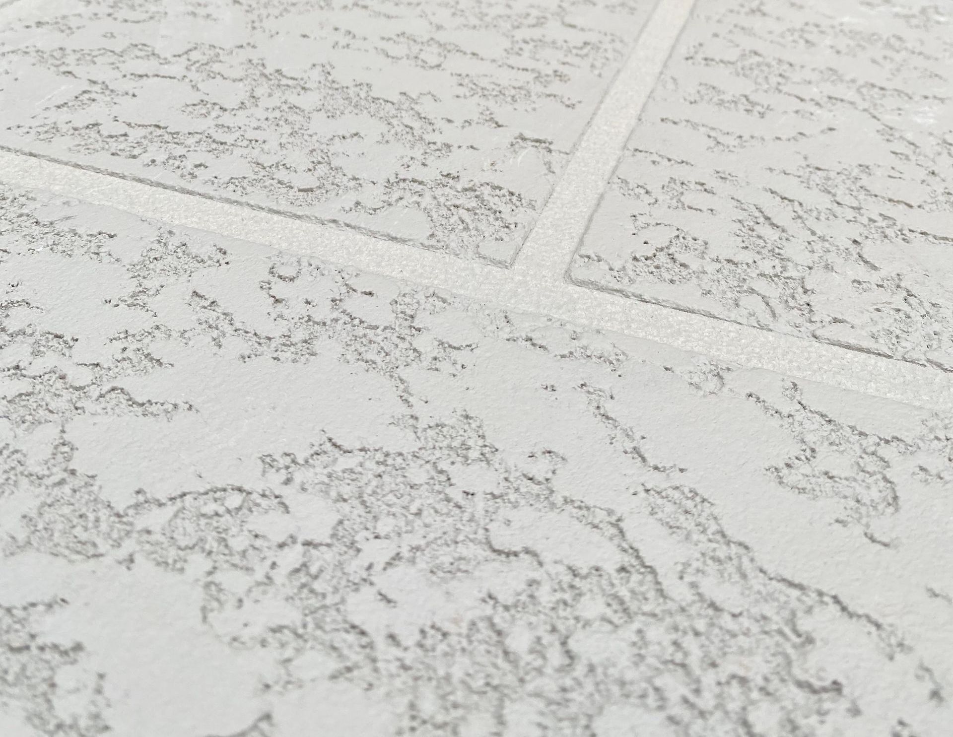 a person using a paint roller to paint a wall