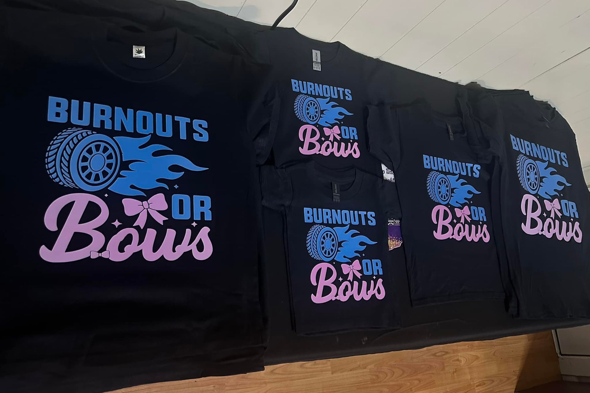 A bunch of burnouts or bows t-shirts on a table